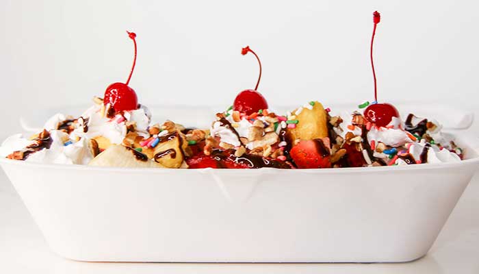 Banana split treat topped with cherries from ice cream menu at at Frutti Labs in Kyle TX.